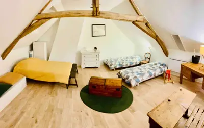 Un ou plusieurs lits dans un hébergement de l'établissement Appartement dans maison avec jardin privatif