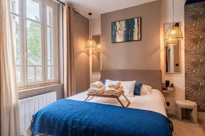 Un ou plusieurs lits dans un hébergement de l'établissement Résidence Saint-Louis - Appart'Hôtel tout-équipé