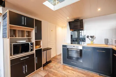 Cuisine ou kitchenette dans l'établissement Le Loft, chic et cozy