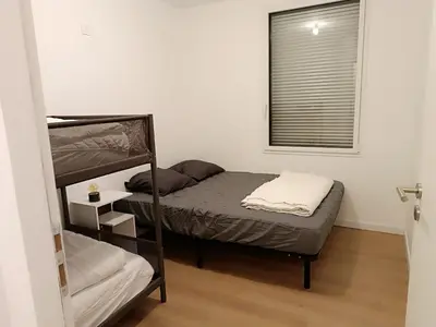 Un ou plusieurs lits dans un hébergement de l'établissement Maison et studio 12 personnes 12 kilomètres du parc du puy du f