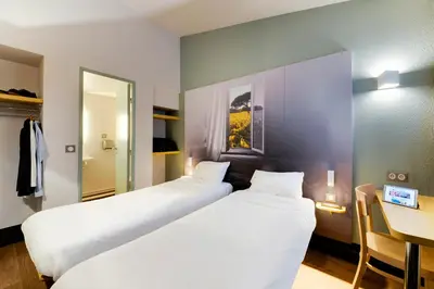 Un ou plusieurs lits dans un hébergement de l'établissement B&B HOTEL Nantes Parc Expos La Beaujoire