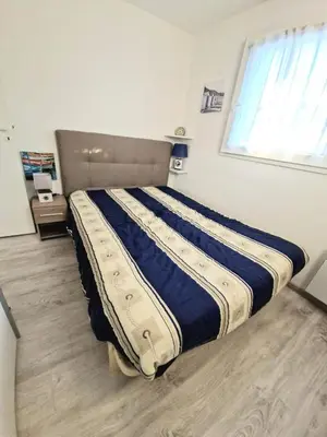 Un ou plusieurs lits dans un hébergement de l'établissement Appartement piscine mer et commerces proche
