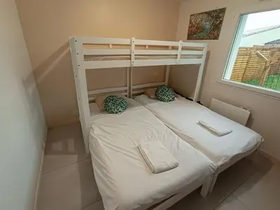 Un ou plusieurs lits dans un hébergement de l'établissement Maison 4 personnes avec jardin à 15 min du grand Parc