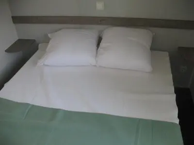 Un ou plusieurs lits dans un hébergement de l'établissement CAMPING Fleur de briere
