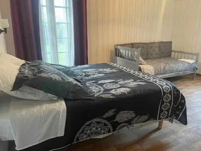 Un ou plusieurs lits dans un hébergement de l'établissement Maison 100m2 chez Gaston