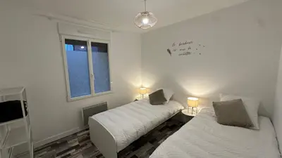 Un ou plusieurs lits dans un hébergement de l'établissement Maison cosy proche Aéroport de Nantes