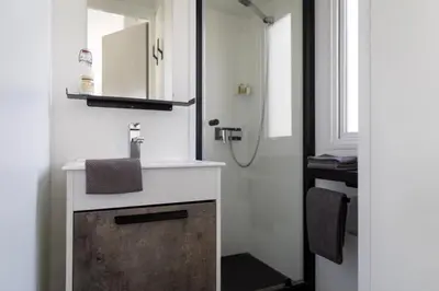Salle de bains dans l'établissement ZEcamping 4 animé piscine couverte 1km plage fitness mobil-home TV