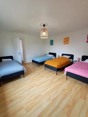 Un ou plusieurs lits dans un hébergement de l'établissement Les Mains Dorées Gîte