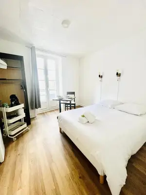 Un ou plusieurs lits dans un hébergement de l'établissement Apparthotel Beauregard 12 cœur de Nantes WIFI