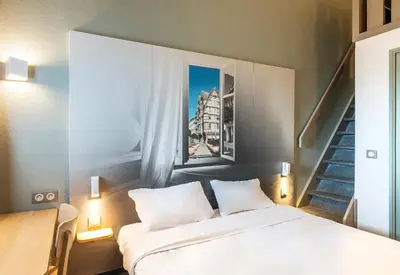 Un ou plusieurs lits dans un hébergement de l'établissement B&B HOTEL Angers 1 Beaucouzé