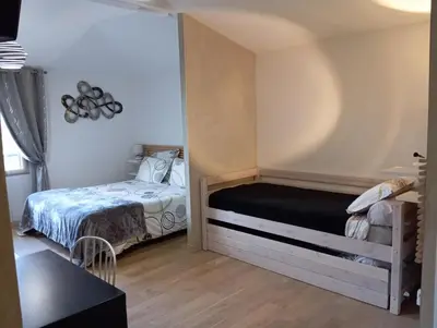 Un ou plusieurs lits dans un hébergement de l'établissement Homgaïa chambres d'hôtes