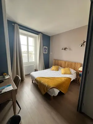 Un ou plusieurs lits dans un hébergement de l'établissement Hôtel de Bretagne