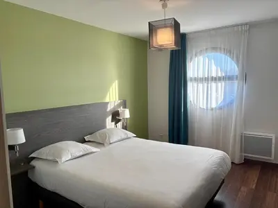 Un ou plusieurs lits dans un hébergement de l'établissement Zenitude Hôtel-Résidences Nantes Métropole