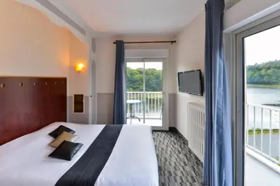 Un ou plusieurs lits dans un hébergement de l'établissement Contact Hotel Le Moulin Neuf Chantonnay