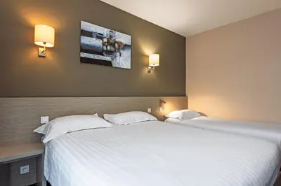 Un ou plusieurs lits dans un hébergement de l'établissement Park Hôtel & Appartements