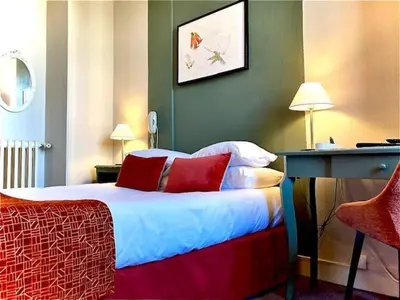 Un ou plusieurs lits dans un hébergement de l'établissement Hôtel Coeur De Loire