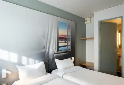 Un ou plusieurs lits dans un hébergement de l'établissement B&B HOTEL Saint-Nazaire Trignac