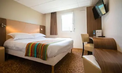 Un ou plusieurs lits dans un hébergement de l'établissement Brit Hotel Le Kerann Nantes St Herblain - Zac De La Lorie