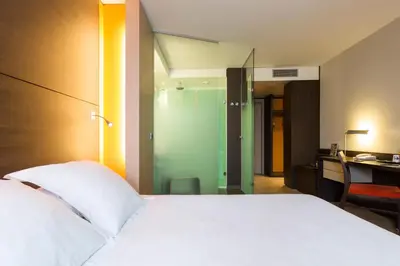 Un ou plusieurs lits dans un hébergement de l'établissement Hôtel Oceania Nantes Aéroport