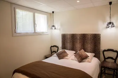 Un ou plusieurs lits dans un hébergement de l'établissement Chambres Au Jardin Fleuri