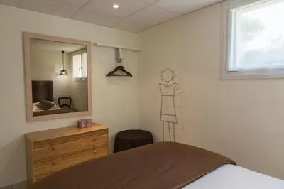 Un ou plusieurs lits dans un hébergement de l'établissement Chambres Au Jardin Fleuri