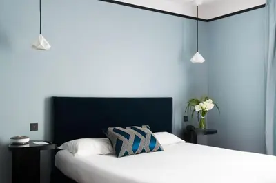 Un ou plusieurs lits dans un hébergement de l'établissement LHotel - face au château - boutique hôtel et séminaires