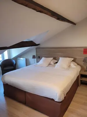 Un ou plusieurs lits dans un hébergement de l'établissement L'Hotellerie de la Toile à Beurre