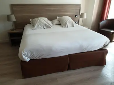 Un ou plusieurs lits dans un hébergement de l'établissement L'Hotellerie de la Toile à Beurre