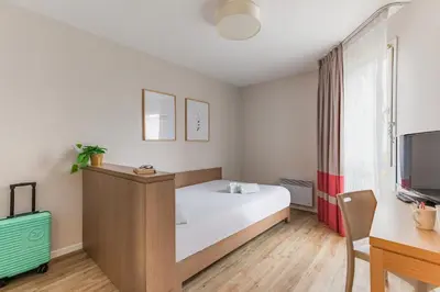 Un ou plusieurs lits dans un hébergement de l'établissement Appart'City Classic Nantes Quais de Loire