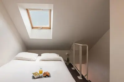 Un ou plusieurs lits dans un hébergement de l'établissement Appart'City Classic Nantes Quais de Loire