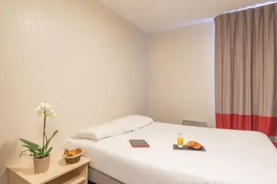 Un ou plusieurs lits dans un hébergement de l'établissement Appart'City Classic Nantes Quais de Loire