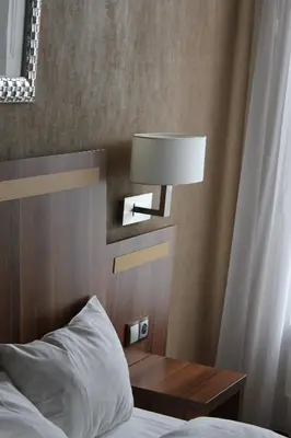 Un ou plusieurs lits dans un hébergement de l'établissement Hotel The Originals du Grand Monarque Nantes Gare