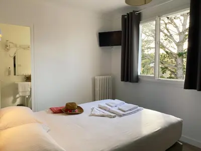 Un ou plusieurs lits dans un hébergement de l'établissement Maison Esperanza hôtel et appartement
