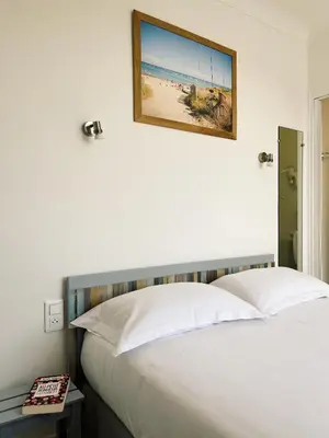 Un ou plusieurs lits dans un hébergement de l'établissement Maison Esperanza hôtel et appartement