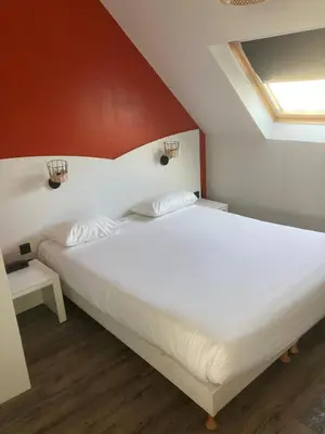 Un ou plusieurs lits dans un hébergement de l'établissement Brit Hotel Saint-Nazaire Centre