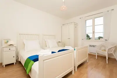 Un ou plusieurs lits dans un hébergement de l'établissement Madame Vacances Les Villas de Fontenelles