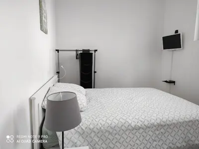 Un ou plusieurs lits dans un hébergement de l'établissement Appart Hôtel L'Angélique