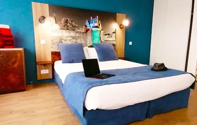 Un ou plusieurs lits dans un hébergement de l'établissement Appart-Hotel Mer & Golf City Ile de Nantes