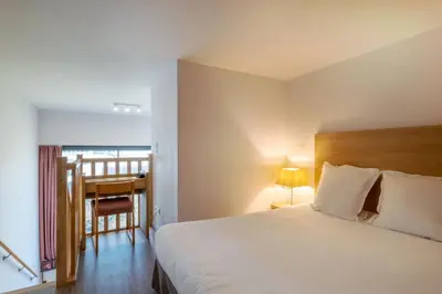 Un ou plusieurs lits dans un hébergement de l'établissement Appart'hôtel Odalys City - Nantes Cité des congrès