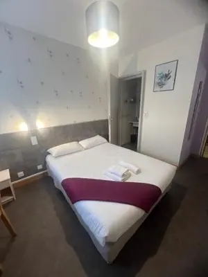 Un ou plusieurs lits dans un hébergement de l'établissement Hotel Le Cormier 9