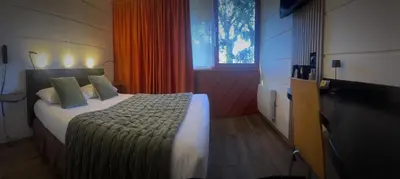 Un ou plusieurs lits dans un hébergement de l'établissement Hôtel du Parc Nantes Ouest Orvault