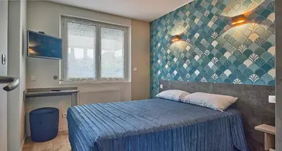 Un ou plusieurs lits dans un hébergement de l'établissement Hotel Restaurant L'Atlantique
