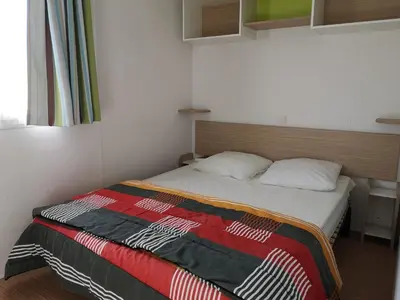 Un ou plusieurs lits dans un hébergement de l'établissement Camping Le Ragis
