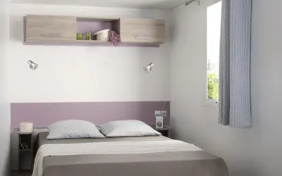 Un ou plusieurs lits dans un hébergement de l'établissement Camping le Rouge Gorge **** 10' Puy du Fou