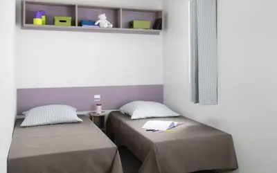 Un ou plusieurs lits dans un hébergement de l'établissement Camping le Rouge Gorge **** 10' Puy du Fou