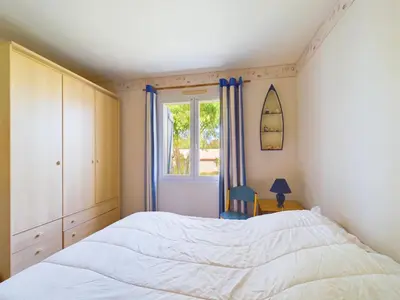 Un ou plusieurs lits dans un hébergement de l'établissement Maison avec jardin - Entre plage et rivière