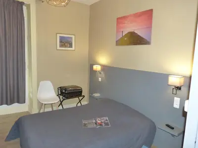 Un ou plusieurs lits dans un hébergement de l'établissement Hôtel Terminus