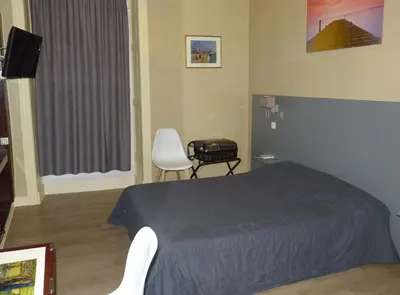 Un ou plusieurs lits dans un hébergement de l'établissement Hôtel Terminus