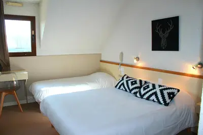 Un ou plusieurs lits dans un hébergement de l'établissement Bel Hotel