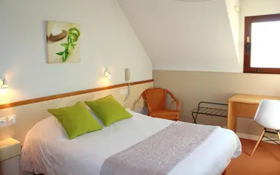 Un ou plusieurs lits dans un hébergement de l'établissement Bel Hotel